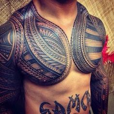 a man with tattoos on his chest and chest