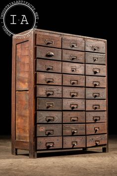 an old wooden cabinet with many drawers on it's sides and the words la above it