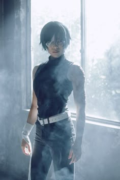 a woman standing in front of a window with steam coming out of her pants and arm