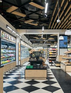 the inside of a grocery store with checkered floor and black and white tile floors