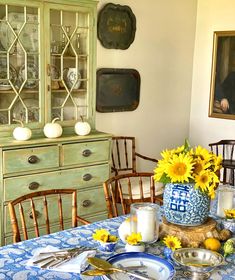 a dining room table with sunflowers on it