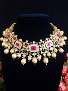 Sabyasachi Bridal Kundan Necklace/Ruby Kundan Necklace/Indian Bridal Necklace/Indian Wedding Necklace/Kundan Wedding Jewelry/Jadau Necklace Features 1-Handmade Gold Plated Indian Kundan Jewelry Necklace and Jhumka Earrings Set. 2-22 K Gold Plated Jewelry 3-Beautiful Wedding Necklace with Statement Earrings. 4-Traditional Kundan/Meenakari/Jadau Necklace Set 5-Handcrafted To Perfection 6-Unique boutique design 7- Perfect Bridal Necklace Set Dimensions: Necklace: Adjustable Fitting Earrings: Approx Luxury Kundan Meenakari Necklace With Ruby, Festive Temple Jewelry Choker For Reception, Heavy Multicolor Necklaces For Wedding, Heavy Pearl Necklace For Festive Occasions, Kundan Choker With Pallu For Wedding, Traditional Festive Choker For Reception, Kundan Bridal Necklace With Tilla For Celebration, Wedding Chandbali Choker With Zari Work, Multicolor Chandbali Necklaces For Reception