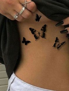 a woman's stomach with butterflies on her back and the bottom part of her body