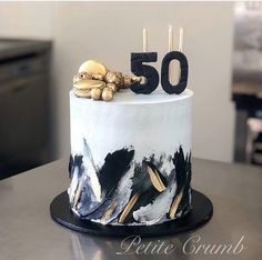 a white and black cake sitting on top of a table