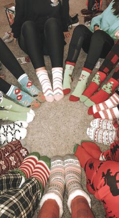 a group of people sitting in a circle wearing socks