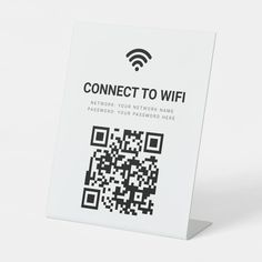 a white sign with a qr code on it