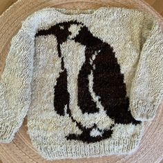 a knitted sweater with an image of a penguin on it