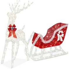 two lighted reindeer sleighs with bows on them