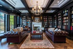 a living room filled with lots of furniture and bookshelves next to a fire place