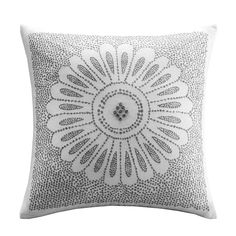 a white pillow with an intricate design on it