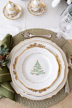 a place setting with plates, silverware and napkins