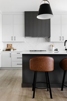 two stools are in front of the kitchen island