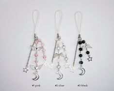 three charms with different designs hanging from them