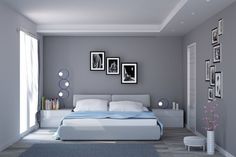 a bedroom with gray walls and pictures on the wall