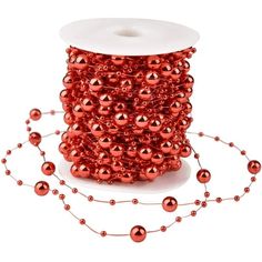 a spool of red beading on a white background