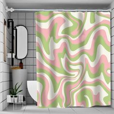 a bathroom with a pink and green shower curtain in the shape of an abstract design