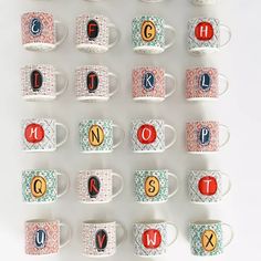 many coffee cups with letters and numbers on them are arranged in a gridded pattern