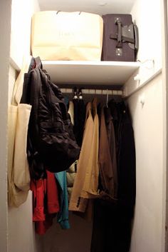 the closet is full of clothes and luggage