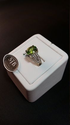 "Oval Peridot and Diamond Ring. This Genuine Peridot measures approximately 9x11 millimeters, set in 14kt White Gold split-shank band with .25ct White Diamond total weight. Clean Classic lines make this a must for any Collection. **Ring size: small 7 **August Birthstone. Pantone Green 2017 color of the year. **This item can be sized up or down 2 sizes for an additional $35.00 Please feel free to contact me anytime, if you have any questions or need any additional information. All items are avail Green Rings With Brilliant Cut Round Stone, Oval Green Diamond Ring With Vs Clarity, Green Brilliant Cut Round Stone Rings, Peridot Rings With Brilliant Cut In Fine Jewelry Style, Fine Jewelry Peridot Rings With Brilliant Cut, Green Peridot Rings With Brilliant Cut, Peridot Round Birthstone Ring For Formal Occasions, Formal Round Peridot Birthstone Ring, Lime Green Diamond Rings For Anniversary