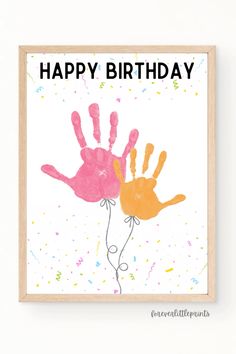 a handprinted birthday card with the words happy birthday and two hands on it