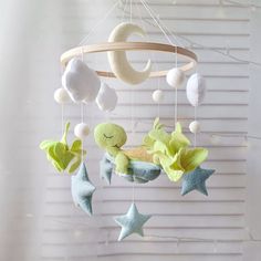 a baby crib mobile with stars and moon decorations