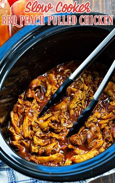 slow cooker bbq peach pulled chicken in a crock pot with tongs