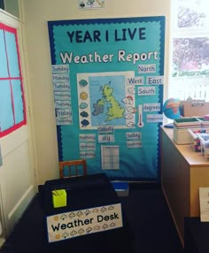 a classroom with desks and posters on the wall that read year i live weather report