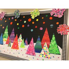 a bulletin board decorated with christmas trees and snowflakes