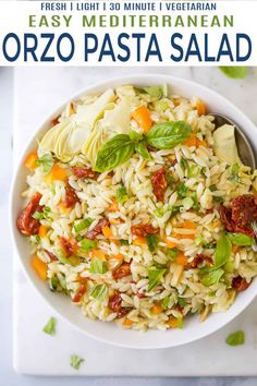 a white bowl filled with pasta salad next to two bowls of seasoning and spices