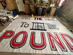 there is a large sign on the floor that says, take the dags to it's time to pound