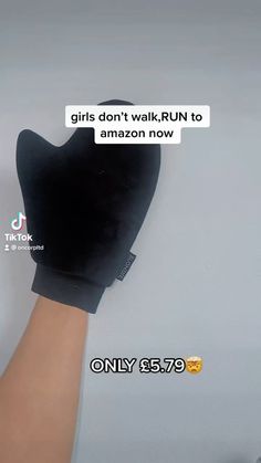 a person's hand holding up a pair of black slippers with text reading girls don't walk, run to amazon now