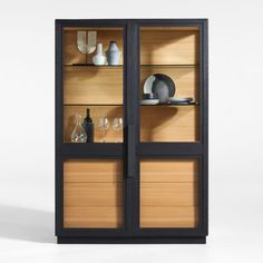 a black and wood display cabinet with glass doors on the front, two shelves below