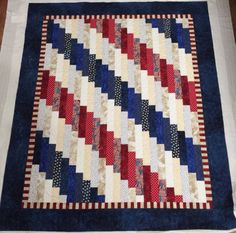 a red, white and blue quilt on a table