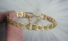 "ELEGANT PERIDOT    GEMSTONE  BANGLE BRACELET IN  14KT ROLLED GOLD  20 4MM PERIDOT GEMSTONES   HANDCRAFTED IN 14KT ROLLED GOLD  IN A UNIQUELY DESIGNED SETTING UNIQUE HANDCRAFTED PIECE THAT WILL GET YOU NOTICED! LIGHTWEIGHT AND EASY TO WEAR SIZE ----- SIZE 6 TO 8 BRACELET IS 1/2 OF AN INCH WIDE ON THE SIDES BRACELETE IS  1/2   INCH WIDE IN FRONT iTS COMFORTABLE HEAVY DUTY HOOK AND CATCH MAKES IT EASY TO TAKE ON AND OFF AN EYE CATCHING PIECE! WEAR IT CASUAL OR FORMAL 7 THINGS TO KNOW ABOUT 14KT ROLLED GOLD #1. 14 Kt Rolled gold wire is also called gold filled wire------This gold wire was used extensively in the 1800's and early 1900s. It is not used very much today its too expensive.  It is durable that is it is very, very strong and last a long long time. DO NOTCONFUSE IT WITH GOLD PLATE. I Green And Gold Jewelry, Sculpted Jewelry, Gemstone Bangle Bracelets, Peridot Bracelet, Wire Wrapped Bangles, Peridot Jewelry, Gemstone Bangle, Saint Joseph, Dope Jewelry