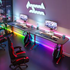 a gaming room with three monitors and two chairs