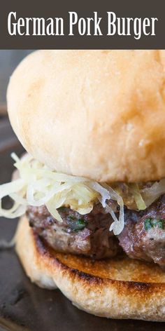 a close up of a hamburger on a plate with text overlay that reads, german pork burger