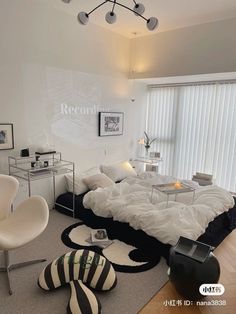 a white bedroom with black and white decor