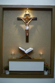 the crucifix is displayed in front of a wall with candles and an open book