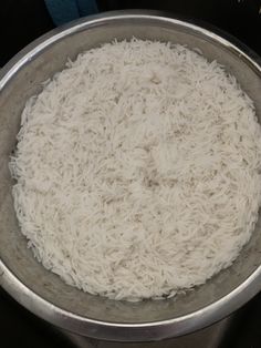 a bowl filled with white rice sitting on top of a stove