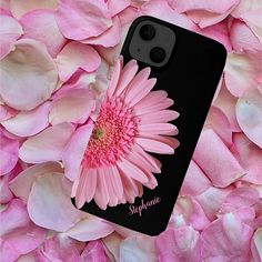 a phone case with a pink flower in the center surrounded by flowers that appear to be blooming