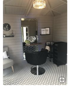 a room with white walls and black furniture