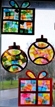 stained glass ornaments are hanging on the window