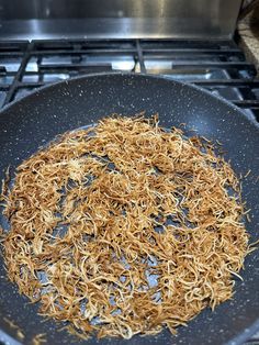 a frying pan filled with food on top of a stove