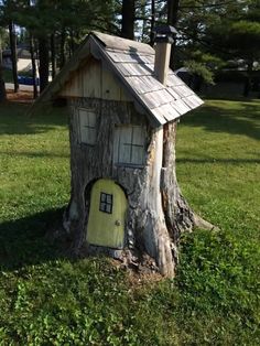 a tree stump with a little house on it