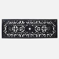 an ornate design is shown on the side of a door mat that has been painted black