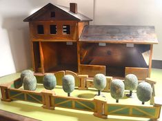 an assortment of fake animals in front of a model house