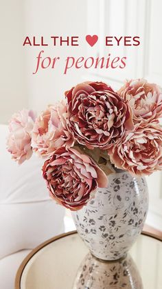 some pink flowers are in a vase on a table with the words all the eyes for peonies