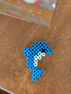 a wooden table topped with blue and white legos