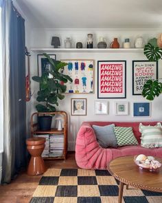 a living room filled with furniture and lots of pictures on the wall above it's coffee table