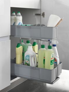 two bins with cleaning products in them on the shelf next to an open refrigerator